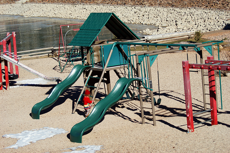 The kids' playground at Bristlecone Park in Brian Head, Utah. Bristlecone Pond is visible in the background of the photo.